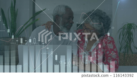 Biracial grandmother and African American father examining digital graphs Biracial grandmother and African American father examining digital graphs 116143392