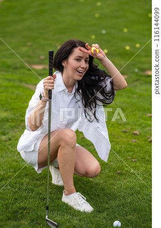 Joyful woman golfer playing game in nature during hot summer day 116144099