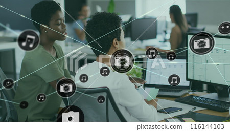 Image of connected icons over diverse female coworkers discussing reports on computer 116144103