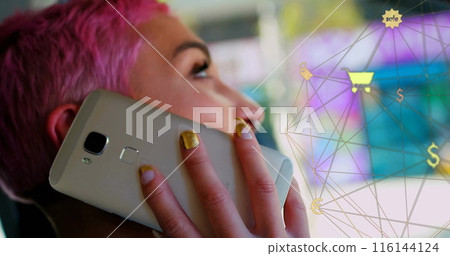 Image of connected icons globe over biracial woman talking on cellphone while sitting in car 116144124