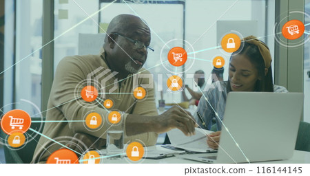 Image of connected icons over diverse coworkers discussing reports on laptop in office Image of connected icons over diverse coworkers discussing reports on laptop in office 116144145