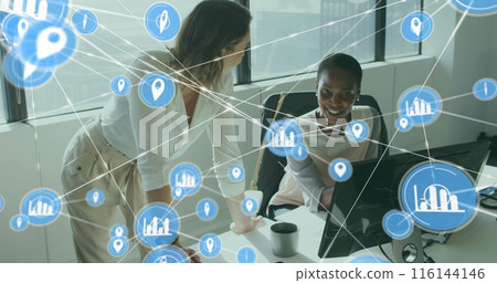 Image of connected icons over diverse female coworkers discussing reports on computer 116144146