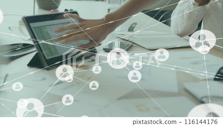 Image of connected icons over diverse coworkers analyzing reports on digital tablet in office 116144176