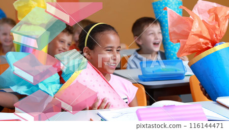 Image of books moving over happy school children in classroom 116144471
