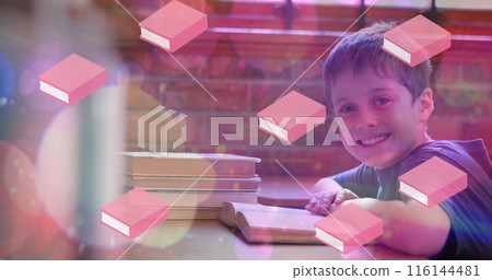 Image of books moving over happy schoolboy reading book at school 116144481