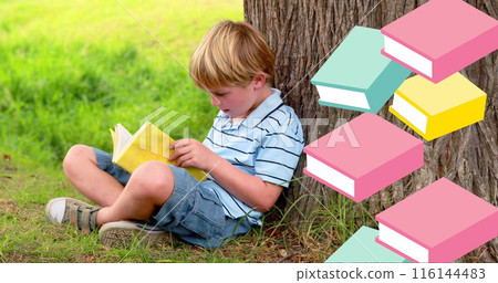 Image of books moving over boy reading book leaning against tree Image of books moving over boy reading book leaning against tree 116144483