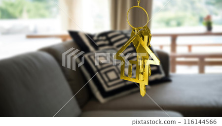 Image of gold key and house key ring over blurred house interior Image of gold key and house key ring over blurred house interior 116144566