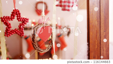 Red star and heart decorations hanging on glass door Red star and heart decorations hanging on glass door 116144663