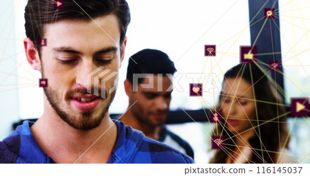 Image of two globes of digital icons over caucasian man smiling while using smartphone at office Image of two globes of digital icons over caucasian man smiling while using smartphone at office 116145037