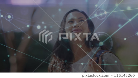 Image of network of connections with spots over biracial woman in city 116145260