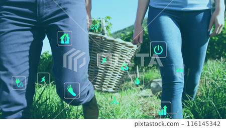 Caucasian couple holding hands, walking in field 116145342