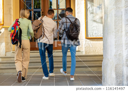 Back view of students walking in university campus Back view of students walking in university campus 116145497