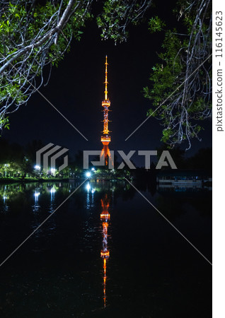 television TV tower illuminated at night in Tashkent in Uzbekistan with a reflection in water of a river 116145623