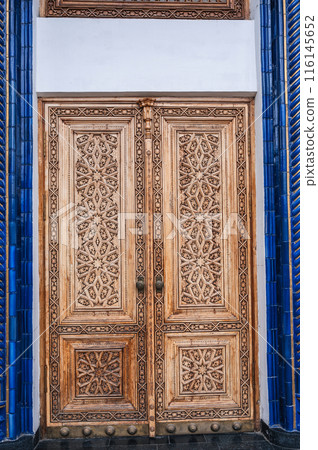 Wooden carved door with oriental pattern Uzbek islamic ornament in Museum of Victims of Political Repression in Tashkent in Uzbekistan 116145652