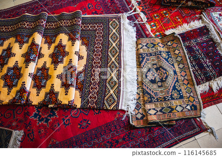 stack of traditional oriental carpets at bazaar in Uzbekistan in Samarkand stack of traditional oriental carpets at bazaar in Uzbekistan in Samarkand 116145685