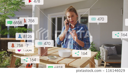 A woman is spending time in her garden and renovating her house while social distancing and self-iso 116146029