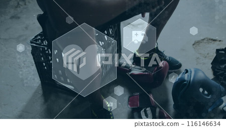 Image of medical and health icons over african american man putting boxing gloves on in gym 116146634