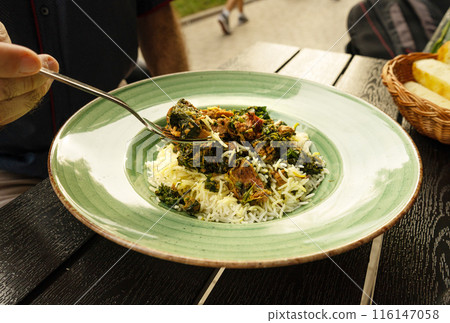 Pilau on Green Plate, Beef Pilaf, Traditional Asian Dish Plov also known as Polow, Pilav, Pallao, Pulao, Palaw 116147058