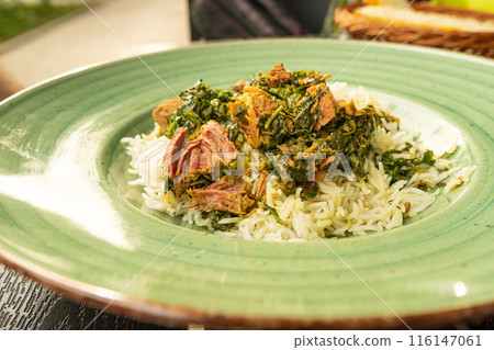 Pilau on Green Plate, Beef Pilaf, Traditional Asian Dish Plov also known as Polow, Pilav, Pallao, Pulao, Palaw Pilau on Green Plate, Beef Pilaf, Traditional Asian Dish Plov also known as Polow, Pilav, Pallao, Pulao, Palaw 116147061