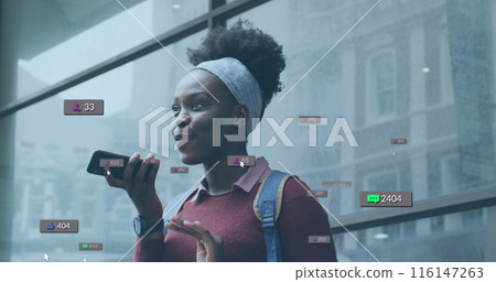 Image of social media icons with numbers over african american woman talking on smartphone 116147263