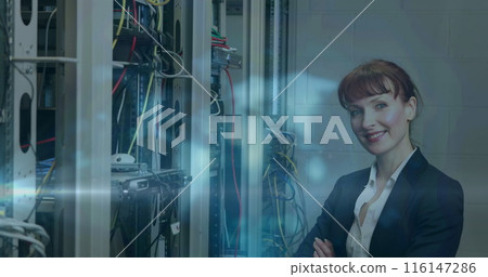 Image of light trails over caucasian female worker in server room 116147286