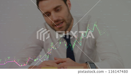 Caucasian male in suit checking his watch, with stock market graphs overlay Caucasian male in suit checking his watch, with stock market graphs overlay 116147480