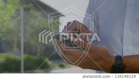 Image of padlock in shield over midsection of caucasian man scrolling on smartphone 116148129