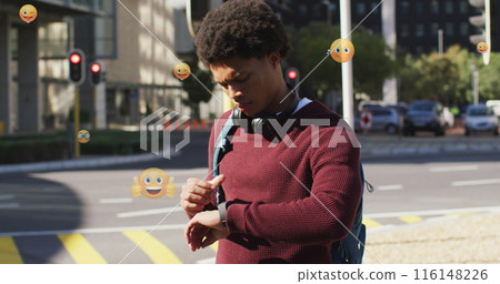 Image of multiple emojis over biracial man walking and scrolling on smartwatch on street Image of multiple emojis over biracial man walking and scrolling on smartwatch on street 116148226