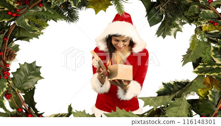 Caucasian woman in Santa costume opening gift, wearing a red hat Caucasian woman in Santa costume opening gift, wearing a red hat 116148301