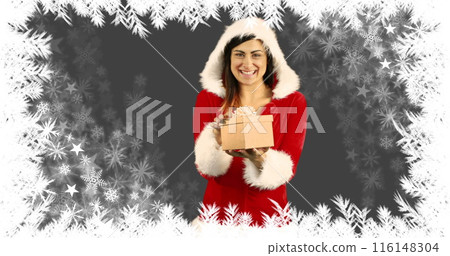 Caucasian sister in red Santa outfit holding gift box, smiling Caucasian sister in red Santa outfit holding gift box, smiling 116148304