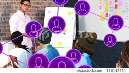 Image of connected icons over diverse manager explaining strategy to coworkers on whiteboard 116148351