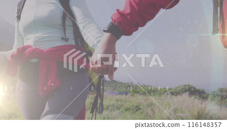 Caucasian couple, both fitness instructors, holding hands while hiking 116148357