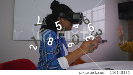 Image of changing numbers over african american woman using vr headset 116148385