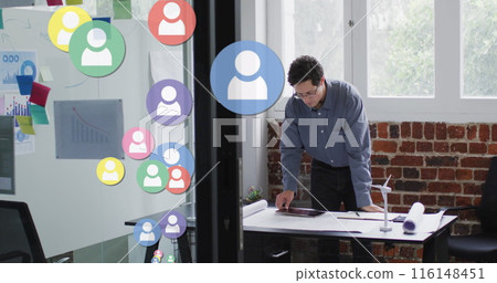 Image of network of connections with icons over businessman in office Image of network of connections with icons over businessman in office 116148451