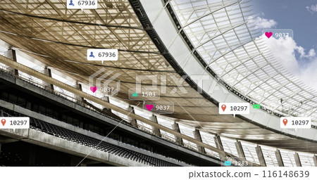 Image of social media icons floating against sports stadium and blue sky 116148639