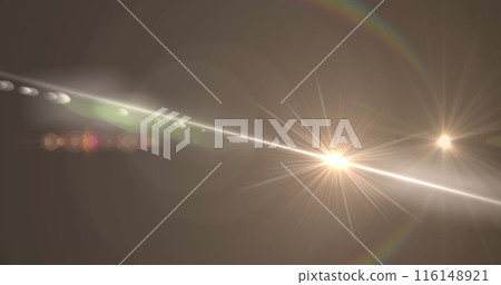 Digital image of spot of light and lens flare against copy space on grey background 116148921