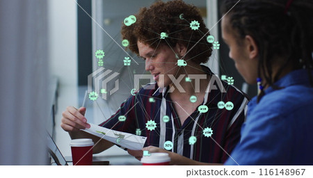 Image of globe of digital icons over two diverse male office colleagues discussing over document 116148967