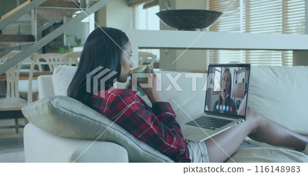 Image of digital screens with diverse data over biracial woman having image call on laptop 116148983