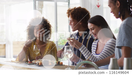 Image of white spot lights over diverse friends having drink in bar Image of white spot lights over diverse friends having drink in bar 116149604
