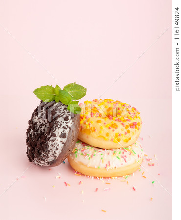 Doughnuts, Chocolate Brown and Pink Donut with Multicolored Sprinkles Doughnuts, Chocolate Brown and Pink Donut with Multicolored Sprinkles 116149824