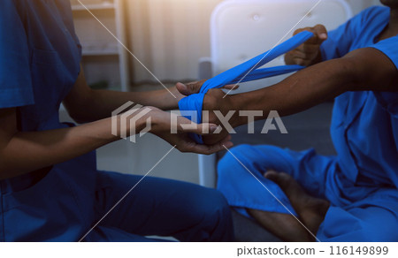 Professional physical therapist examines and cares for a young man in a physical therapy center, treating muscles and injuries of a man in a hospital. 116149899