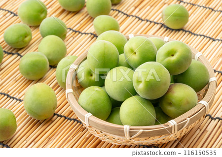 Unripe plums in a basket 116150535