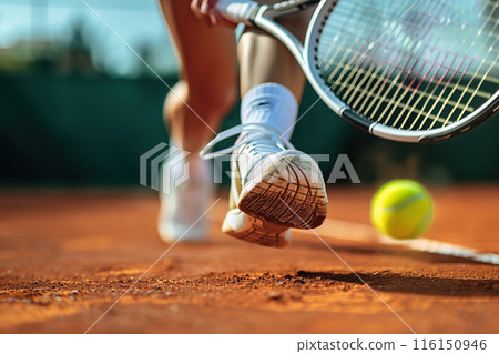 Male tennis player in action on the court on sunny day. Professional sport concept. Horizontal poster, greeting cards, headers, website. Legs of athlete near the tennis racket, ball. Playing Tennis Male tennis player in action on the court on sunny day. Professional sport concept. Horizontal poster, greeting cards, headers, website. Legs of athlete near the tennis racket, ball. Playing Tennis 116150946