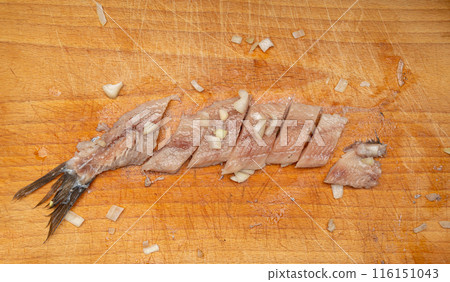 Dutch herring on wooden cutting board, salted fish meat fillet, traditional maatjes, fresh atlantic herring 116151043