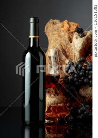 Bottle and glass of red wine. 116151382