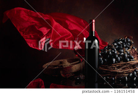 Red wine with grapes on a background of red flutters curtain. 116151458