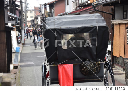 Takayama City, Gifu Prefecture, Japan: During the spring Takayama Festival, a rickshaw runs through the old streets of the center of the city. The back of the vehicle carrying tourists. 116151520