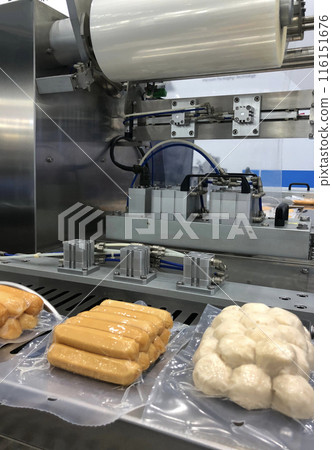 High-performance machines are wrapping processed fresh food products, meatballs sausage.food production lines on conveyor belts, food production industry 116151676