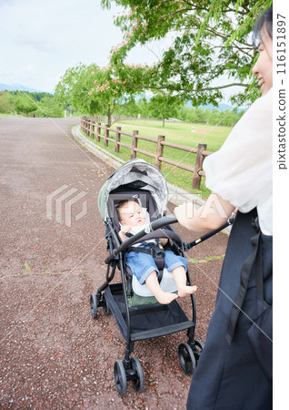 Baby in a stroller and mother childcare 116151897