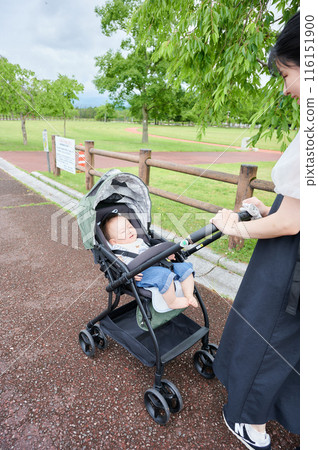 Baby in a stroller and mother childcare Baby in a stroller and mother childcare 116151900